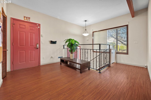 foyer featuring radiator heating unit, hardwood / wood-style flooring, and beamed ceiling