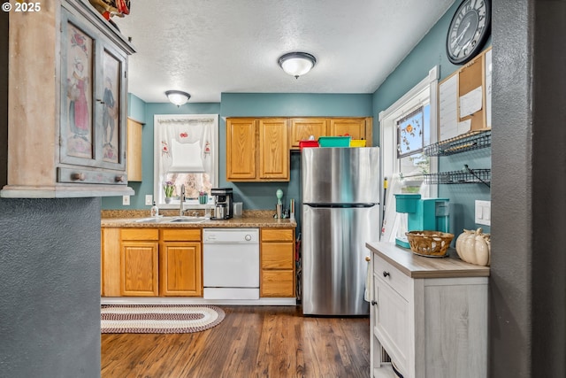 623 10th Ave, Albany, OR 97321 - kitchen with freestanding refrigerator, white dishwasher, dark wood finished floors, light countertops, and a textured ceiling