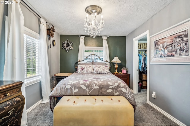 623 10th Ave, Albany, OR 97321 - bedroom featuring carpet floors, a textured ceiling, multiple windows, a chandelier, and a spacious closet