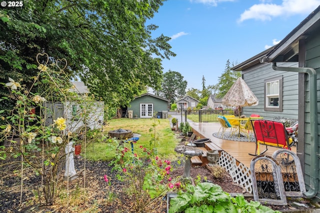 623 10th Ave, Albany, OR 97321 - view of yard with a fire pit, a deck, outdoor dining space, and an outbuilding