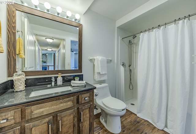 full bathroom with a shower with curtain, toilet, wood finished floors, and vanity