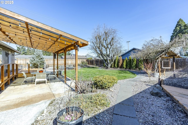 view of yard featuring a patio area, a pergola, and a fenced backyard