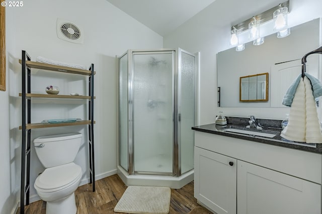 full bath with visible vents, vanity, wood finished floors, and a shower stall