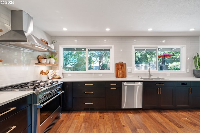 1437 Greentree Cir, Lake Oswego, OR 97034 - kitchen with appliances with stainless steel finishes, a sink, island exhaust hood, backsplash, and light wood finished floors