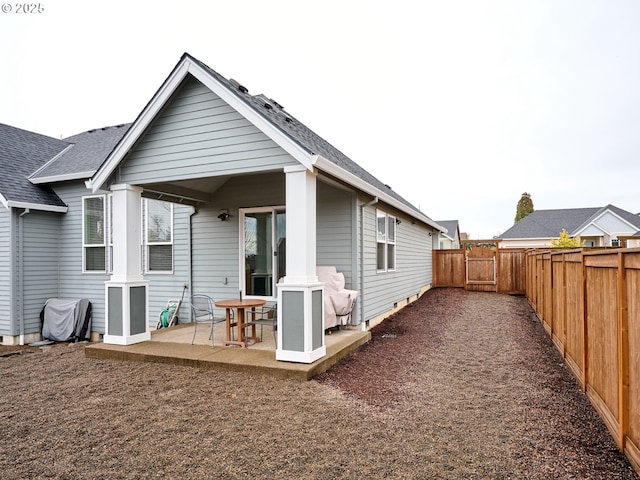 rear view of house with a patio area and a fenced backyard