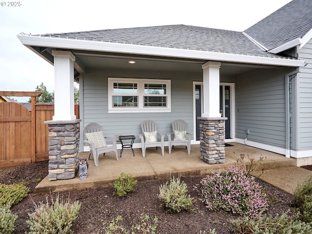 exterior space with a porch and fence