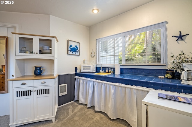 interior space featuring heating unit and carpet flooring