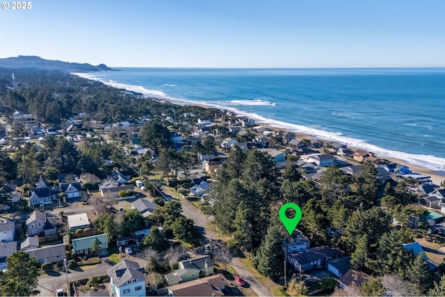 aerial view featuring a beach view, a water view, and a residential view