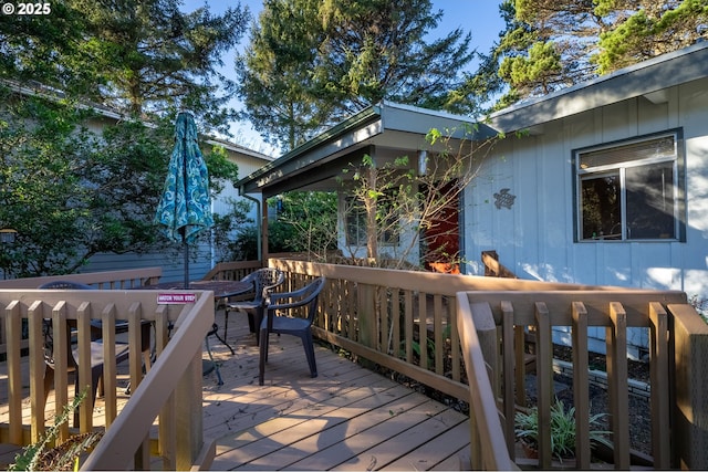 wooden deck featuring outdoor dining area