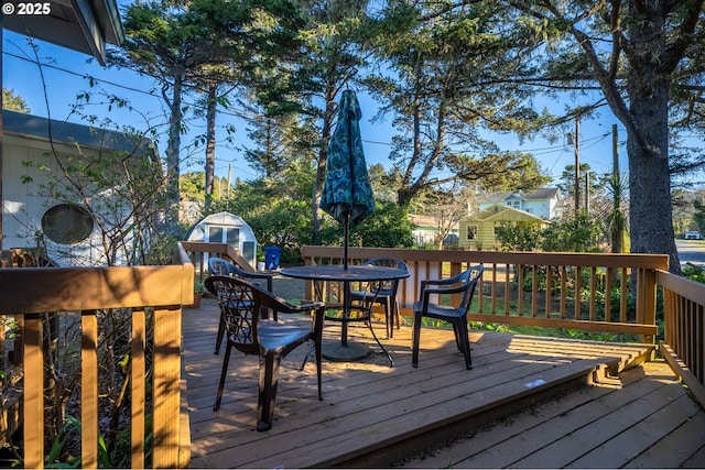 wooden deck featuring outdoor dining area