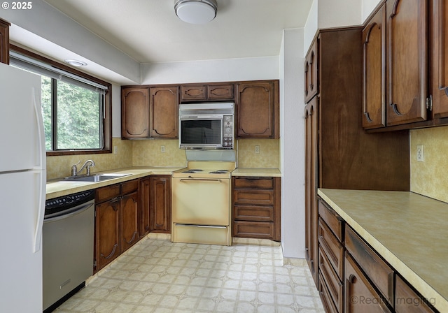 6902 SW 2nd Ave, Portland, OR 97219 - kitchen with appliances with stainless steel finishes, light floors, light countertops, and decorative backsplash