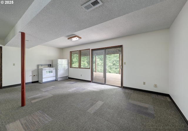 unfurnished living room featuring carpet floors and a textured ceiling