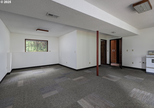 carpeted spare room with a textured ceiling