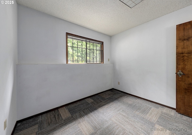 6902 SW 2nd Ave, Portland, OR 97219 - empty room featuring carpet flooring and a textured ceiling