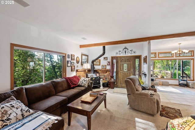 living room featuring a notable chandelier, beamed ceiling, and a wood stove