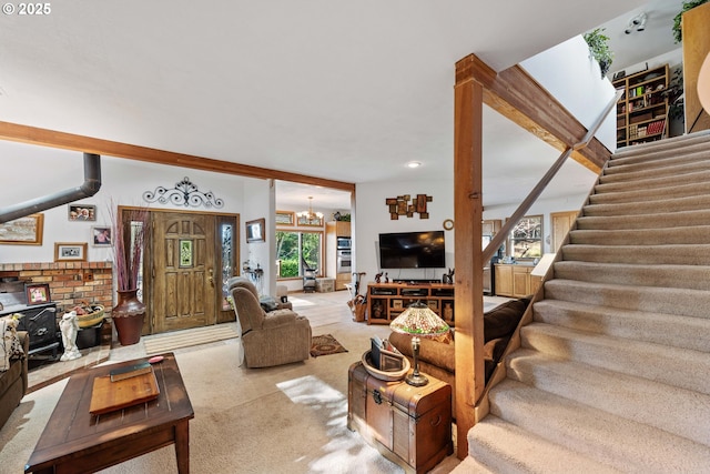 carpeted living room with a wood stove and an inviting chandelier