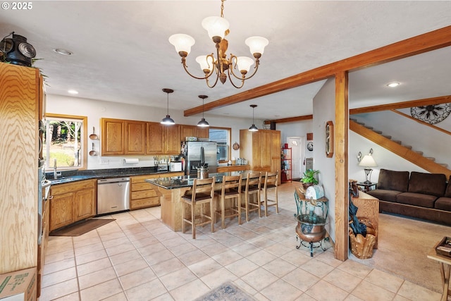 kitchen with light tile patterned flooring, appliances with stainless steel finishes, a breakfast bar, pendant lighting, and sink