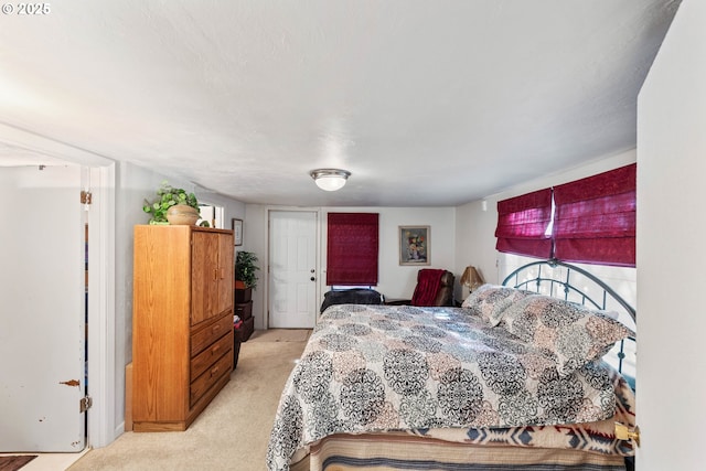 bedroom featuring light colored carpet