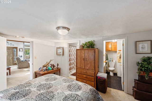 carpeted bedroom with connected bathroom