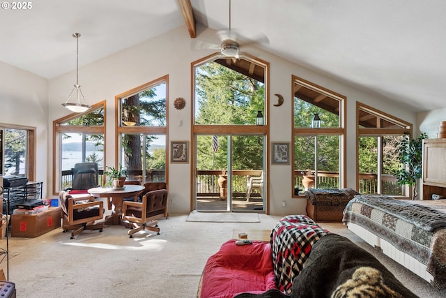 interior space with access to exterior, beam ceiling, and high vaulted ceiling