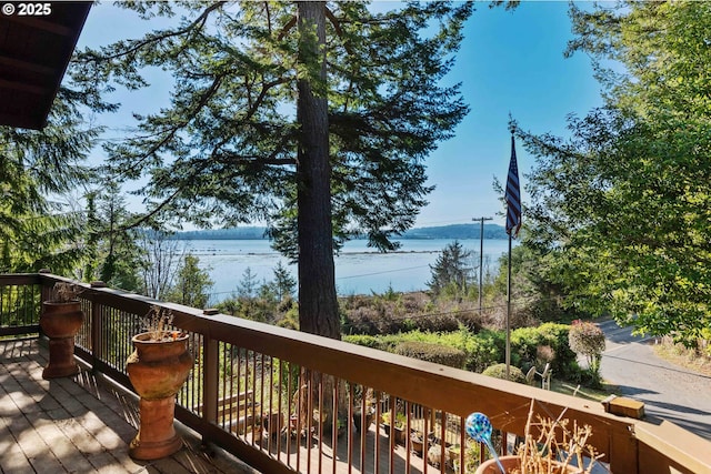 wooden deck featuring a water view