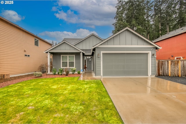 view of front of house featuring a front yard, fence, driveway, a garage, and board and batten siding