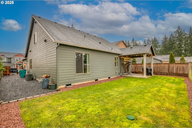 back of property featuring central AC, roof with shingles, a lawn, a fenced backyard, and a patio