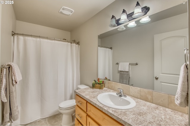 bathroom featuring vanity, tile patterned floors, and toilet