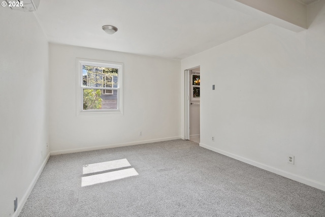 empty room with carpet floors and baseboards