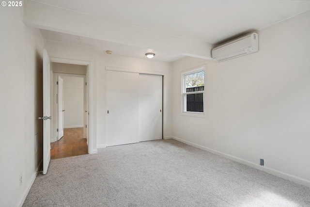 interior space with baseboards and a wall unit AC
