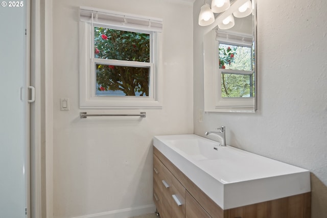 bathroom featuring baseboards and vanity