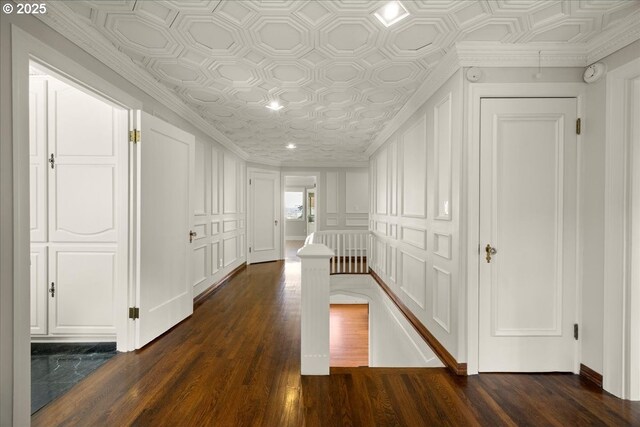 living area featuring baseboards, an ornate ceiling, and dark wood finished floors