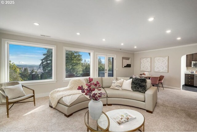 living area with recessed lighting, ornamental molding, and light colored carpet
