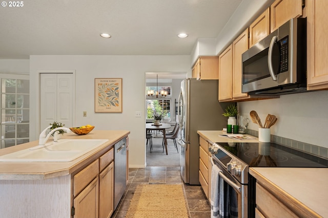 11069 SW Eschman Way, Tigard, OR 97223 - kitchen with appliances with stainless steel finishes, a sink, light brown cabinets, a chandelier, and a center island with sink