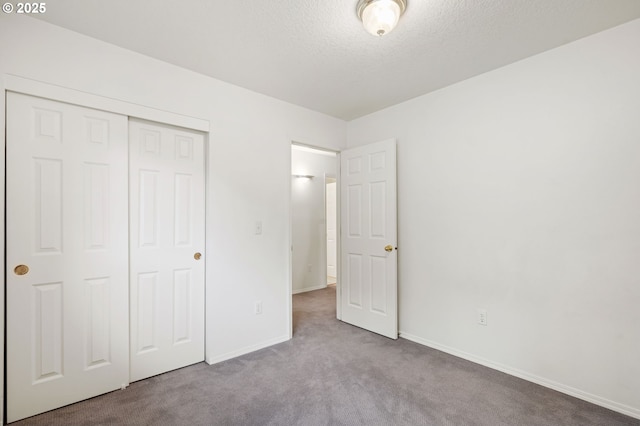 11069 SW Eschman Way, Tigard, OR 97223 - unfurnished bedroom with carpet floors, a textured ceiling, baseboards, and a closet