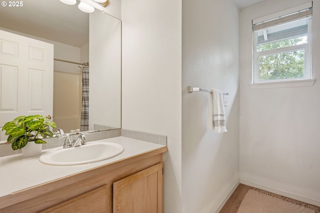 11069 SW Eschman Way, Tigard, OR 97223 - bathroom featuring vanity, baseboards, and wood finished floors