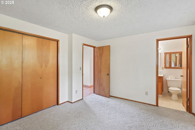 2335 5th St, Columbia City, OR 97018 - unfurnished bedroom with carpet flooring, a closet, ensuite bath, and a textured ceiling