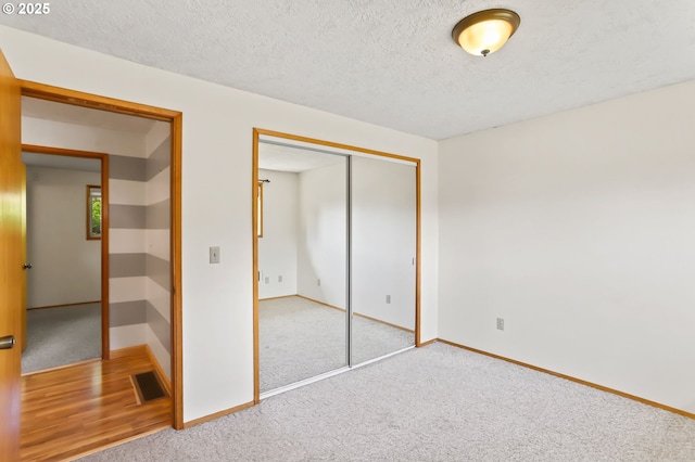 2335 5th St, Columbia City, OR 97018 - unfurnished bedroom featuring carpet, a closet, and a textured ceiling