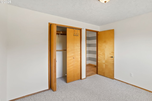 2335 5th St, Columbia City, OR 97018 - unfurnished bedroom featuring a closet, light carpet, and a textured ceiling