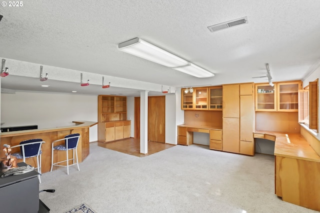 2335 5th St, Columbia City, OR 97018 - office area featuring a textured ceiling, light carpet, and built in desk