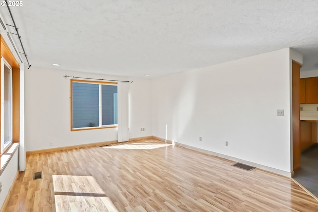 2335 5th St, Columbia City, OR 97018 - empty room with light wood-type flooring, a textured ceiling, and recessed lighting