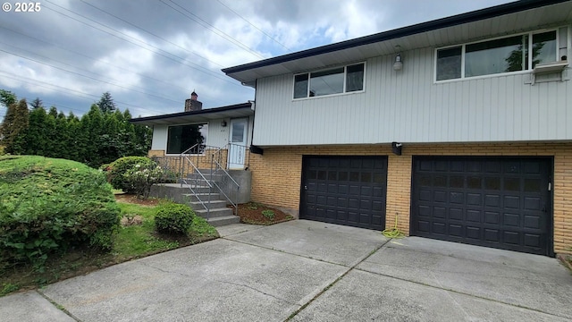 437 SE 154th Ave, Portland, OR 97233 - tri-level home featuring a garage, brick siding, concrete driveway, and a chimney