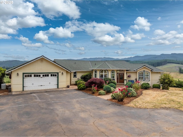 14040 NW Parson Rd, Forest Grove, OR 97116 - ranch-style house featuring a mountain view, driveway, a garage, and covered porch