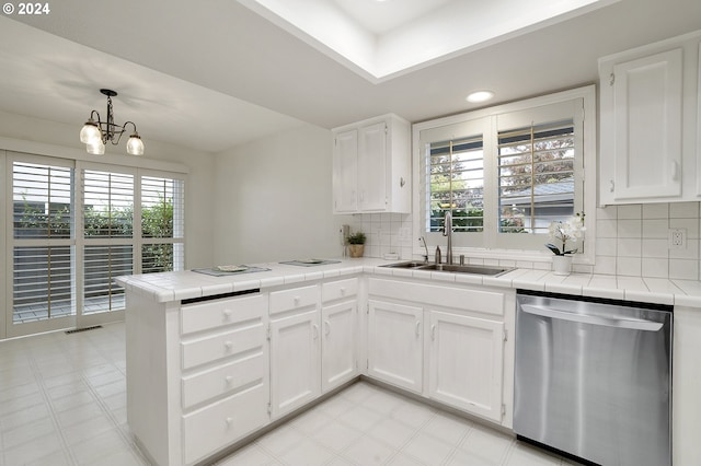 8070 SW Fairway Dr, Wilsonville, OR 97070 - kitchen featuring stainless steel dishwasher, a sink, a peninsula, tile counters, and recessed lighting
