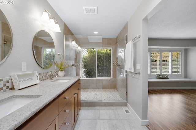 8070 SW Fairway Dr, Wilsonville, OR 97070 - bathroom with double vanity, tiled shower, baseboards, and recessed lighting