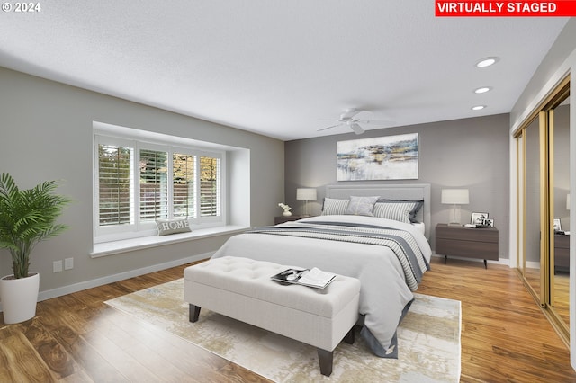 8070 SW Fairway Dr, Wilsonville, OR 97070 - bedroom with light wood-style floors, recessed lighting, baseboards, a closet, and a textured ceiling