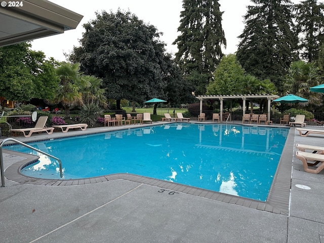8070 SW Fairway Dr, Wilsonville, OR 97070 - community pool with a pergola, a patio, and view of wooded area