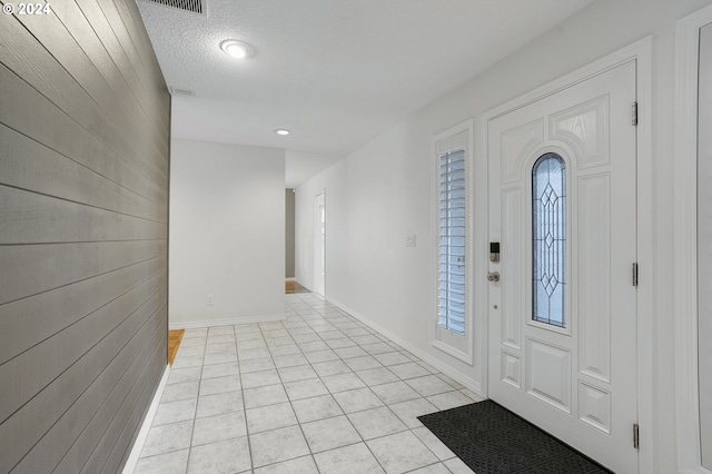 8070 SW Fairway Dr, Wilsonville, OR 97070 - foyer entrance with light tile patterned floors, wooden walls, and baseboards