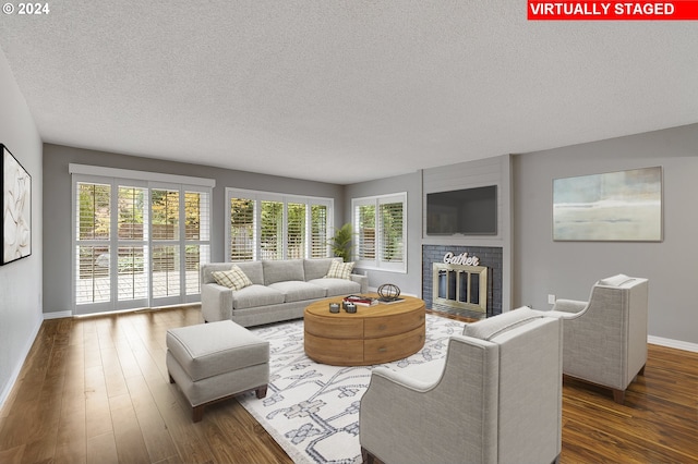 8070 SW Fairway Dr, Wilsonville, OR 97070 - living room with a textured ceiling, baseboards, plenty of natural light, and dark wood-type flooring