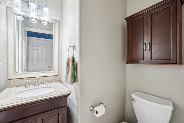 bathroom with toilet and vanity